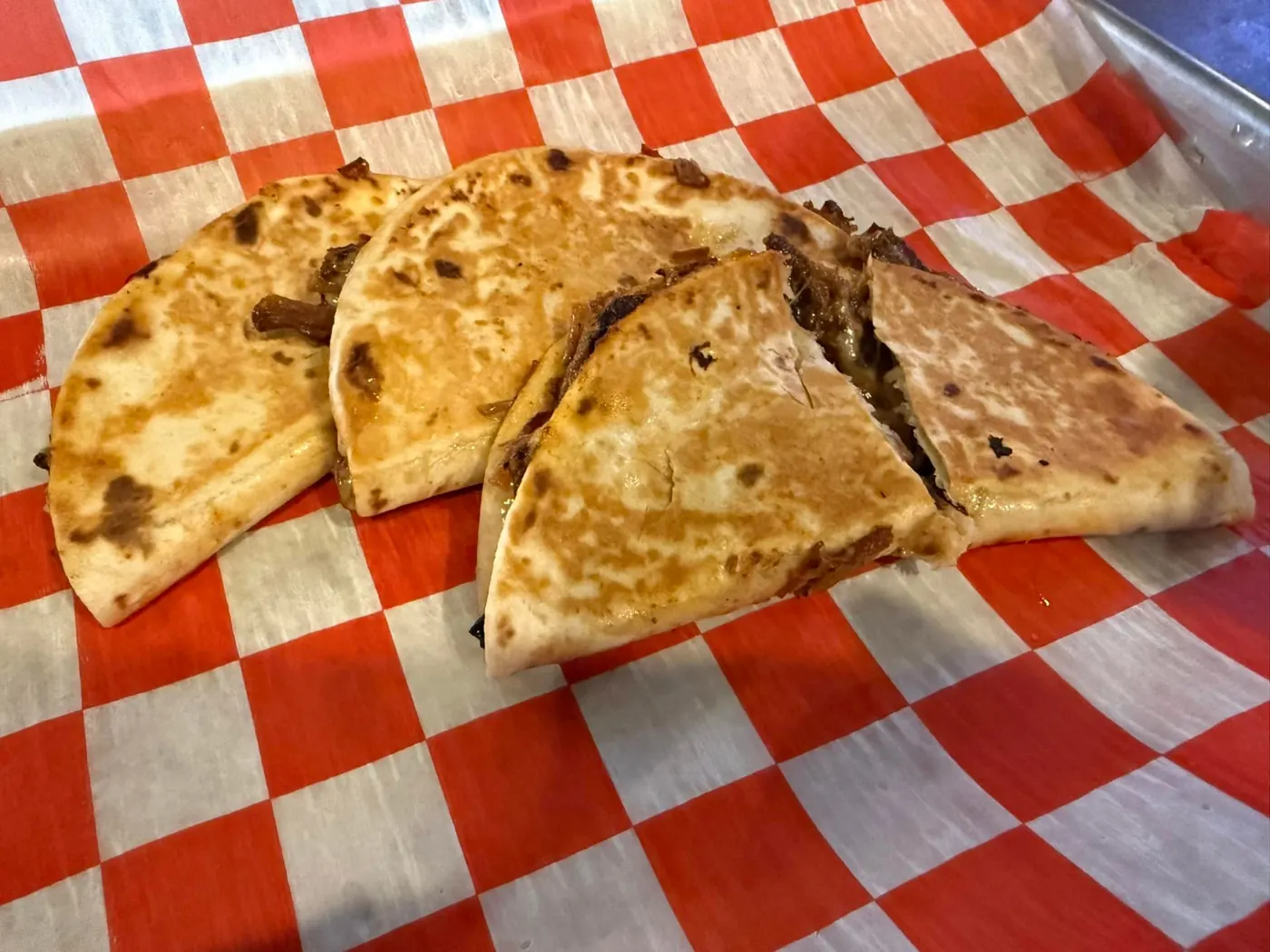 Brisket quesadilla cut into wedges