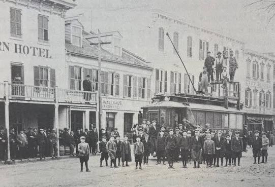 A crowd gathered on Main Street in Waterloo, Illinois, outside the hotel and Wallhaus Hardware